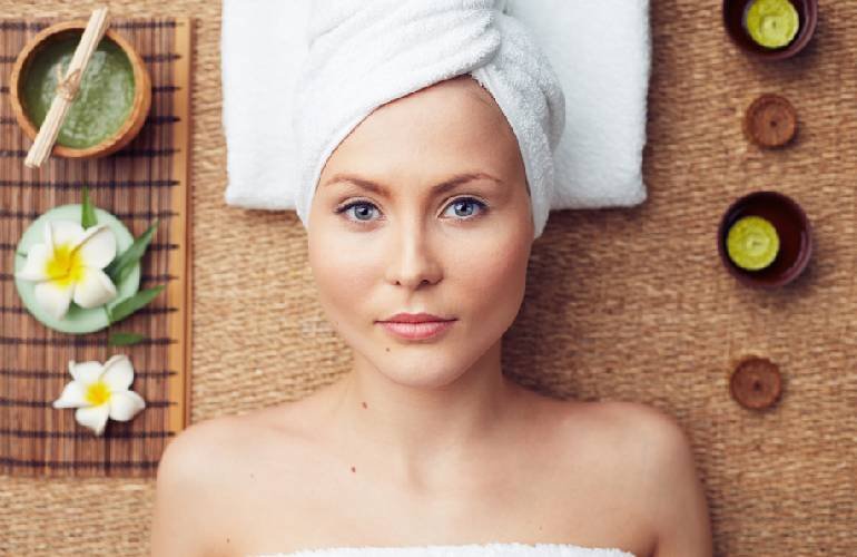 Mujer de ojos azules con una toalla en la cabeza